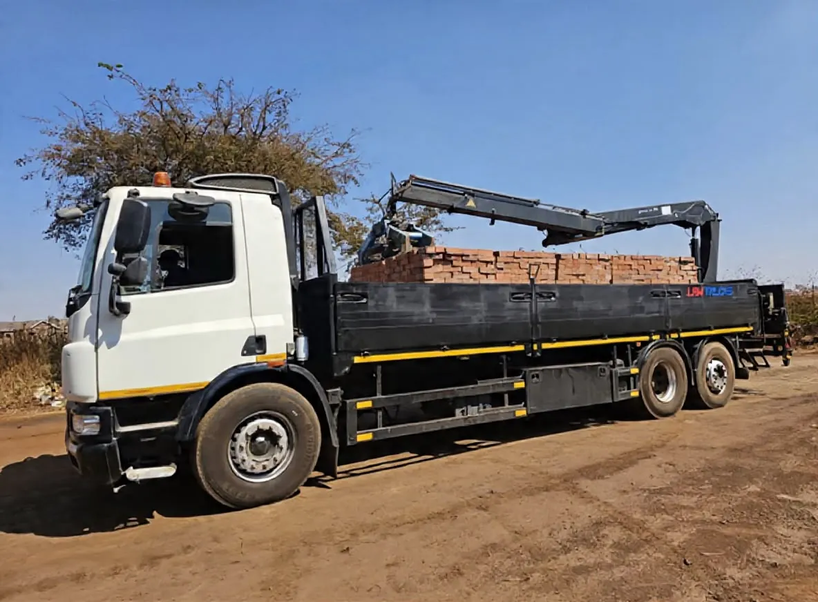 Crane truck lifting bricks onto its deck
