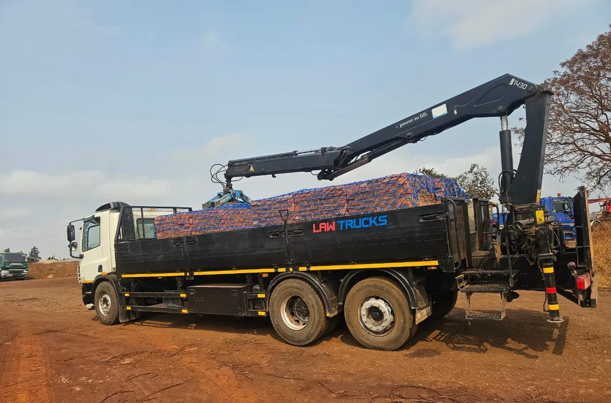 Crane truck loaded with pallets of bricks at the yard